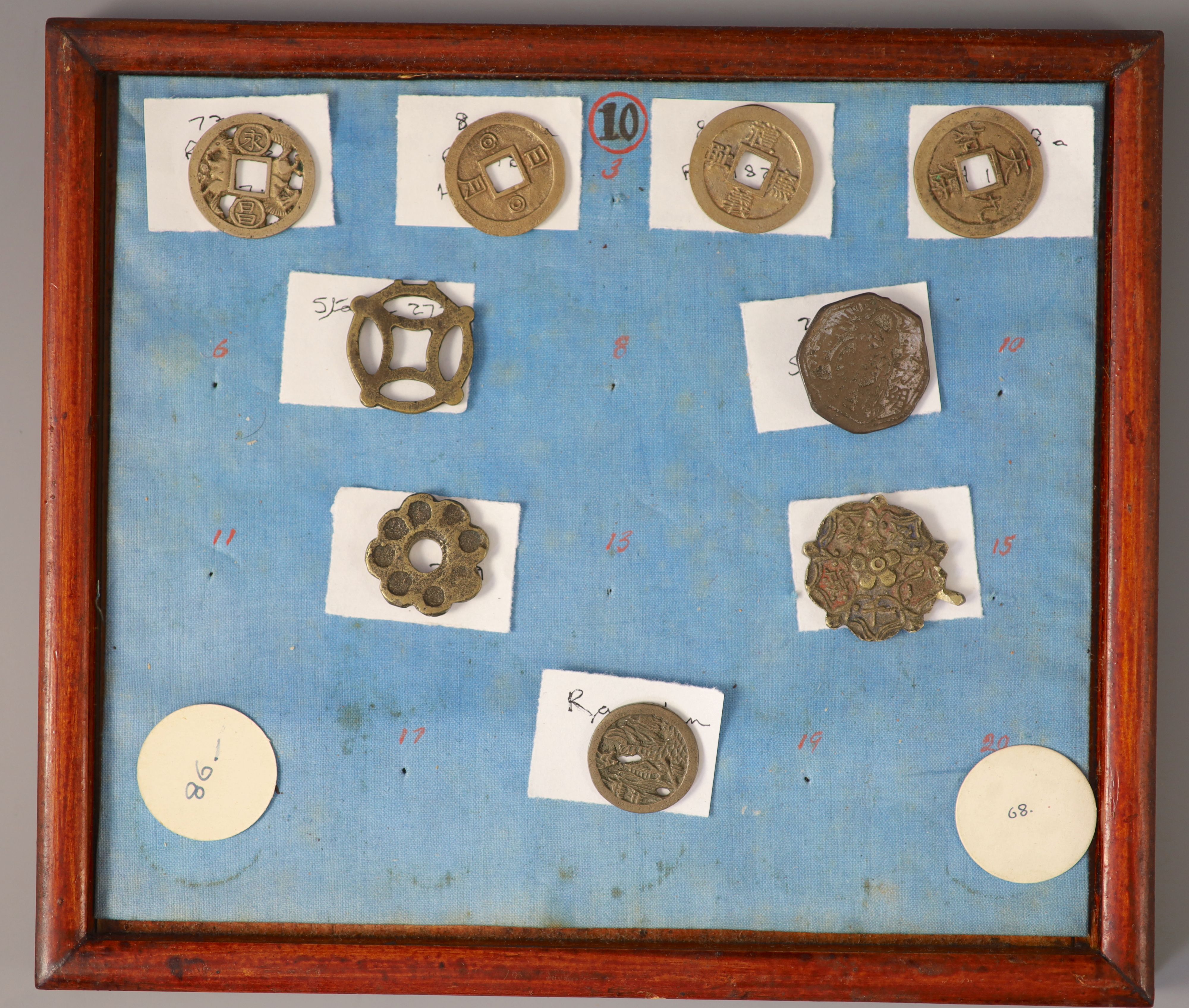 A group of 99 Korean bronze and metal amulets or charms, 19th/20th century